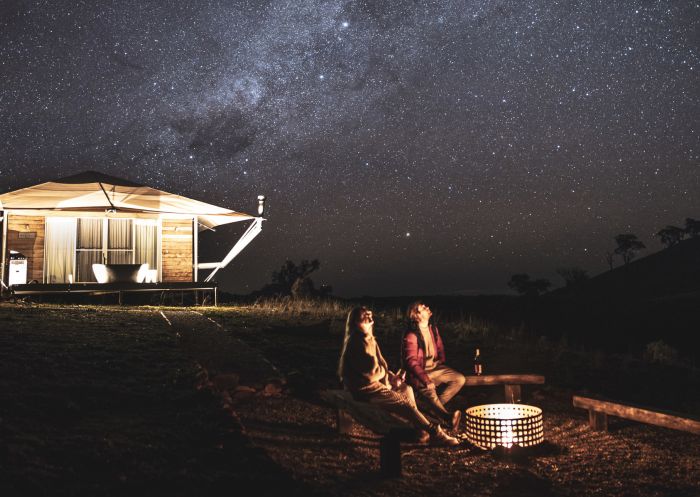 Couple enjoying the firepit while stargazing from the Dulli Tent at Sierra Escape, Piambong in Mudgee