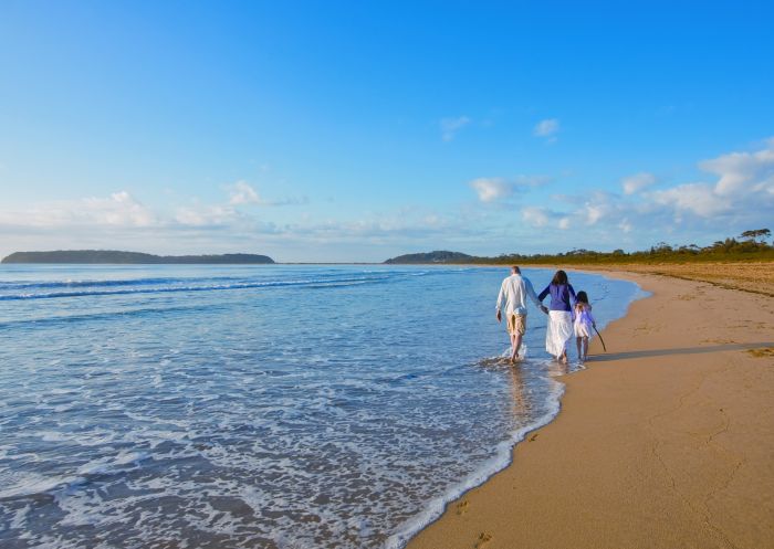 Family walk along Broulee Beach in Eurobodalla, South Coast