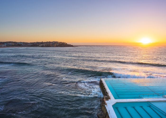 Morning sun rising over Bondi Icebergs, Bondi Beach