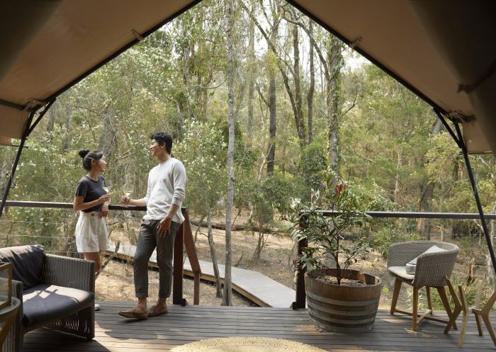 Couple enjoying a romantic glamping getaway at Paperbark Camp, Woollamia in Jervis Bay
