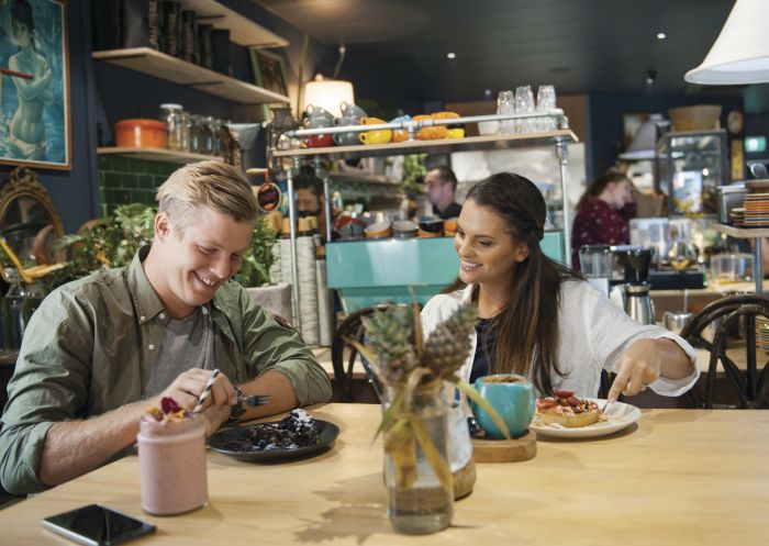 Couple enjoying food and drink at Flock Cafe in Lismore, North Coast