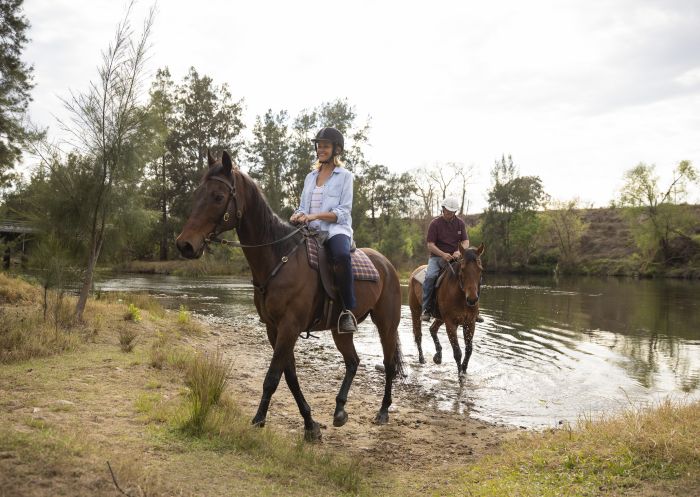 Couple enjoying a horseriding experience with Hawkesbury Valley Equestrian Centre in Hawkesbury, Sydney