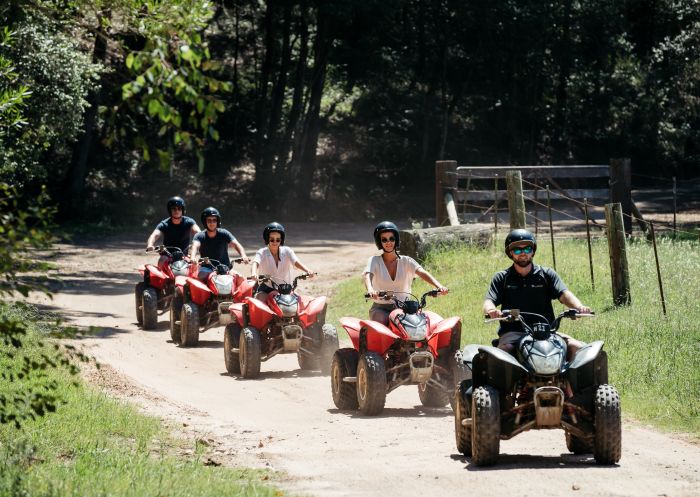 Friends enjoying a guided tour on quad bikes at Glenworth Valley in the Central Coast