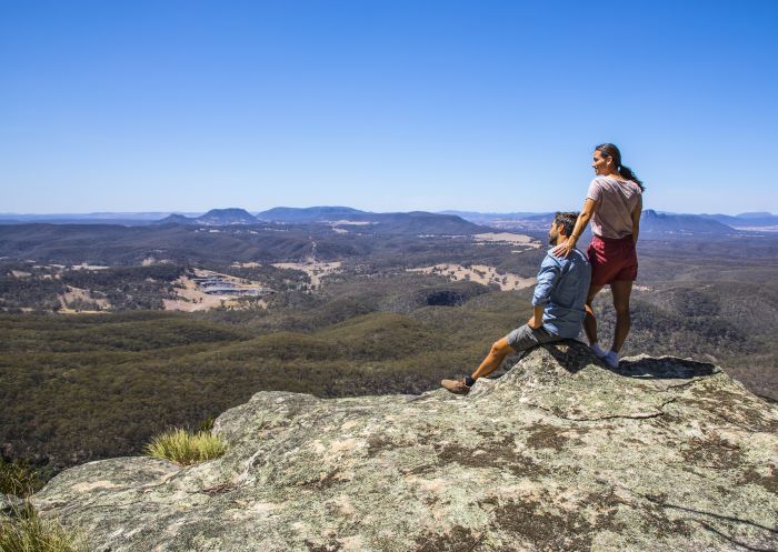 Couple enjoying scenic views across Capertee Valley at Capertee in Lithgow, Blue Mountains