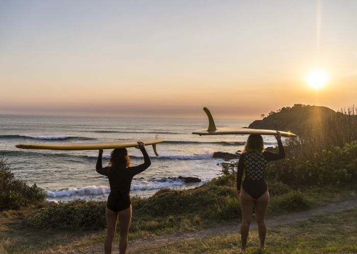 Surfers watching the sunrise at Cabarita Beach - North Coast