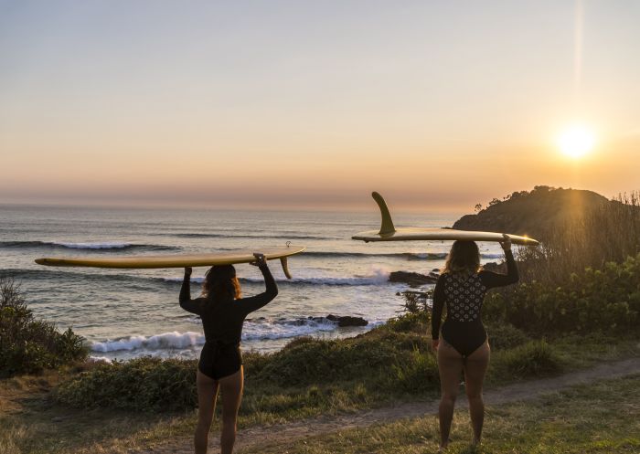 Surfers watching the sunrise at Cabarita Beach - North Coast