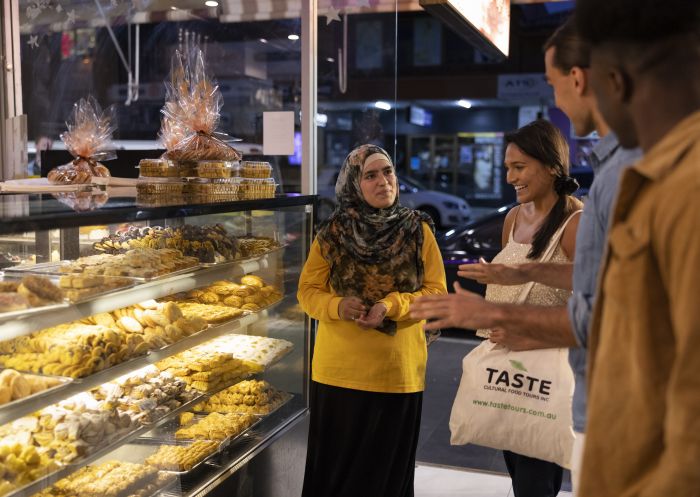 Friends browsing the sweets on display at Asal Sweet, Merrylands