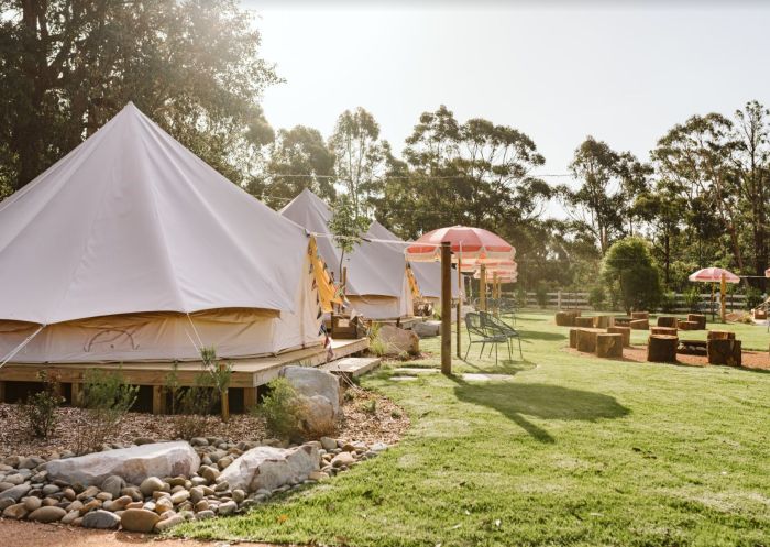Glamping Village including fire pits and outdoor umbrellas for seated area at The Woods Farm, Jervis Bay