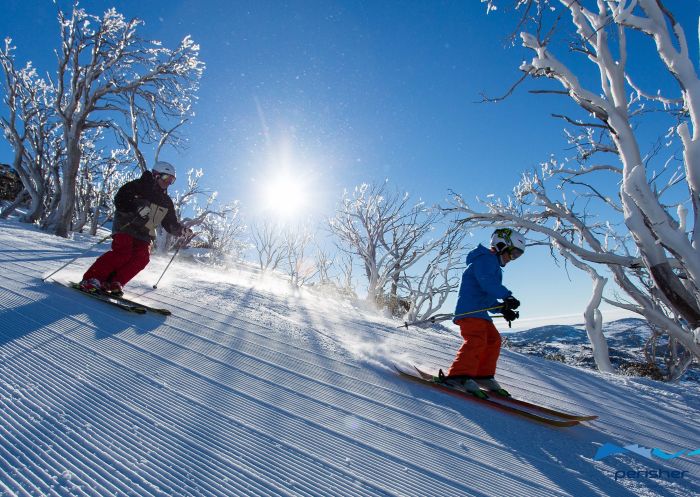 Father and son skiing together in Perisher
