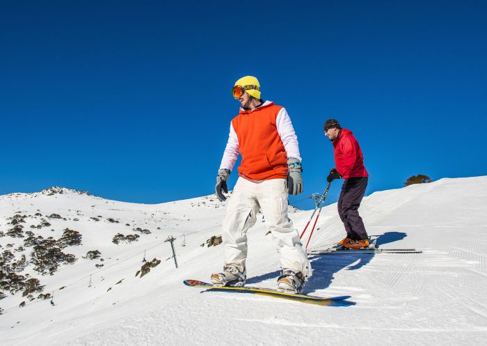 Friends skiing and snowboarding at Charlotte Pass Ski Resort in the Snowy Mountains