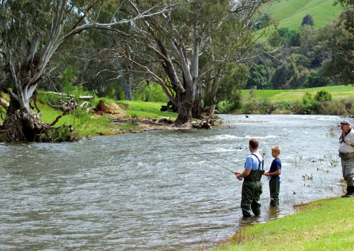 Father and son enjoying a fly fishing lessons on the Goobarragandra River -Tumut - Snowy Mountains