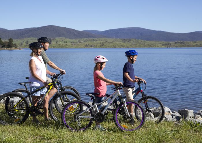 Family enjoying a scenic bike ride around Lake Jindabyne in the Snowy Mountains