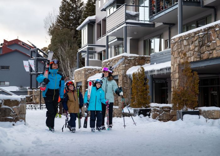 Family heading out for skiing at Thredbo in Kosciuszko National Park, Snowy Mountains