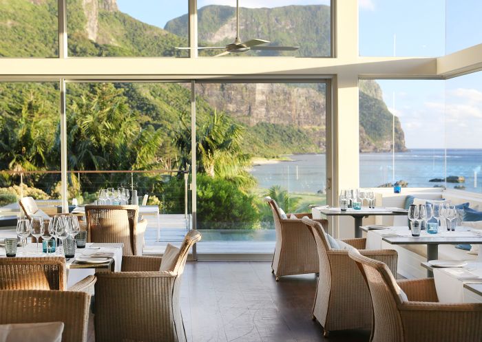 Dining area with scenic coastal views of Mount Gower at Capella Lodge, Lord Howe Island