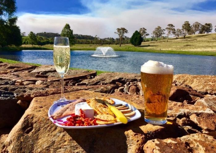 Enjoy afternoon drinks and nibbles by the dam at Deano's Smoked Trout Farm "Ardrossan" in Guyra