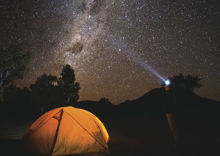 Camper gazing up at the galaxy of stars, Warrumbungles