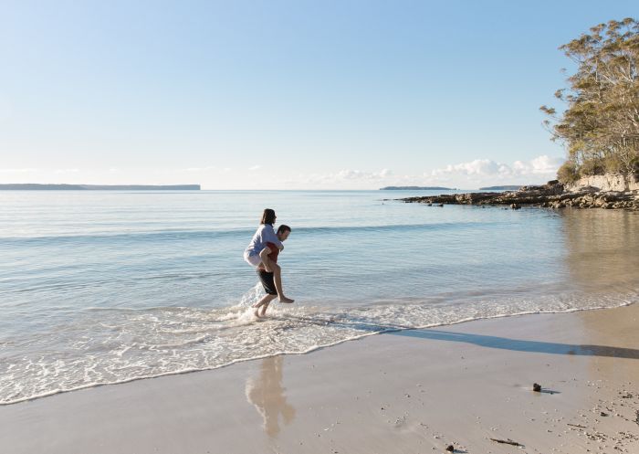 Couple enjoying a visit to Blenheim Beach in Jervis Bay, South Coast