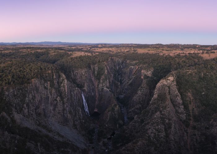 The sun setting over Wollomombi Falls in Oxley Wild Rivers National Park, Walcha.