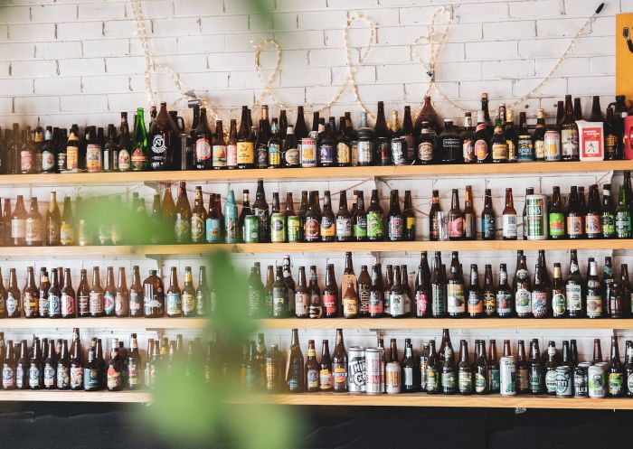 Beer bottles lined up on the wall at Tumut River Brewing Co, Tumut 