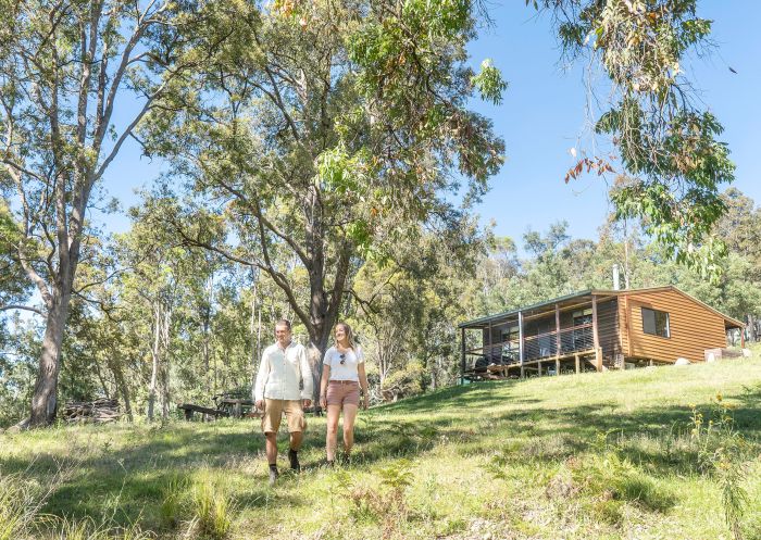Couple standing in front of Galong Cabins, Megalong Valley