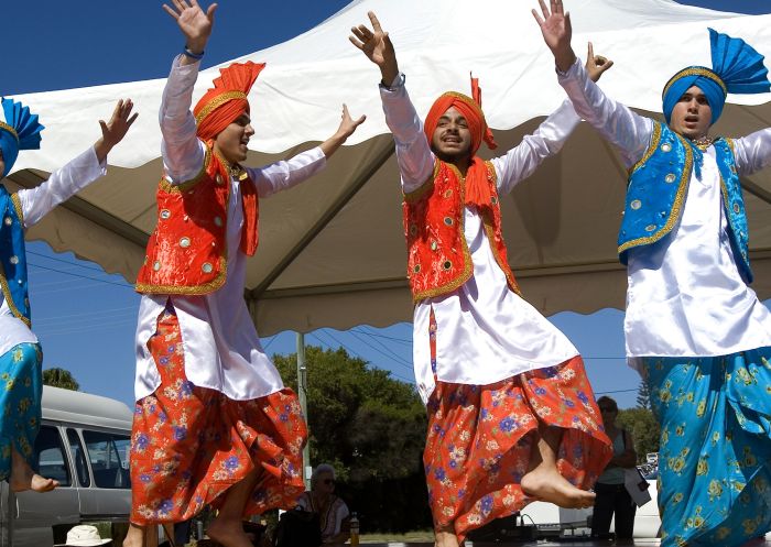 Men dancing on stage in Indian traditional dress at the Woolgoolga Curry Festival, Woolgoolga