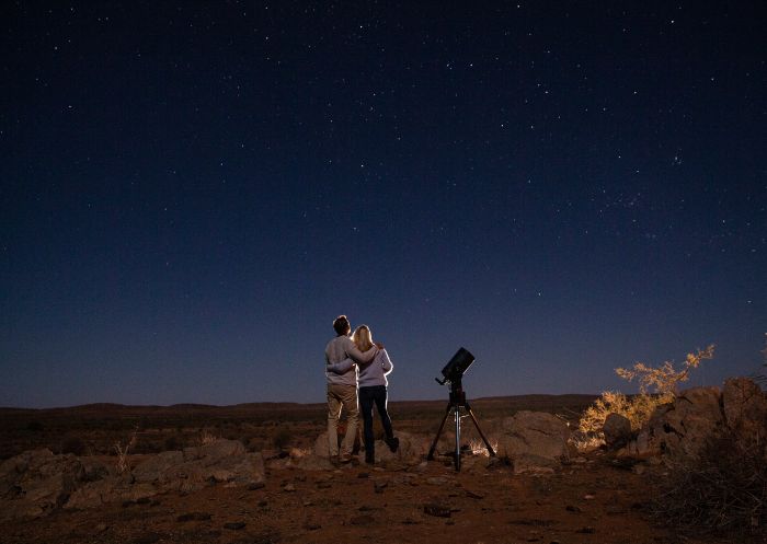 Couple star gazing beneath the Milky Way at Outback Astronomy, Broken Hill 