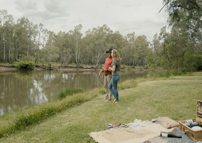 Couple picnicking on the banks of the Murray River at Lions Park, Howlong