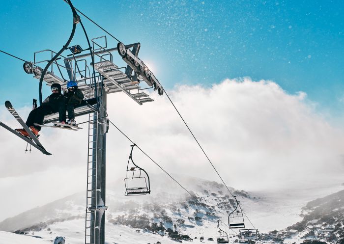 Skiers riding the chairlifts over Charlotte Pass, Snowy Mountains