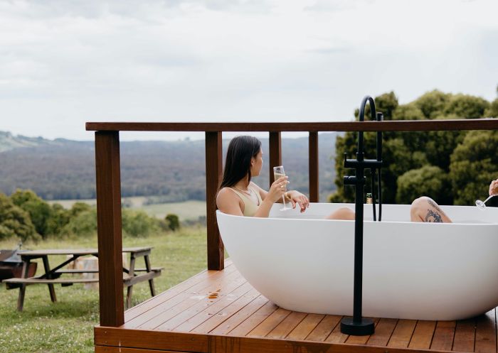 Women enjoying view from bathtub at Into the Wild Escapes, Robertson