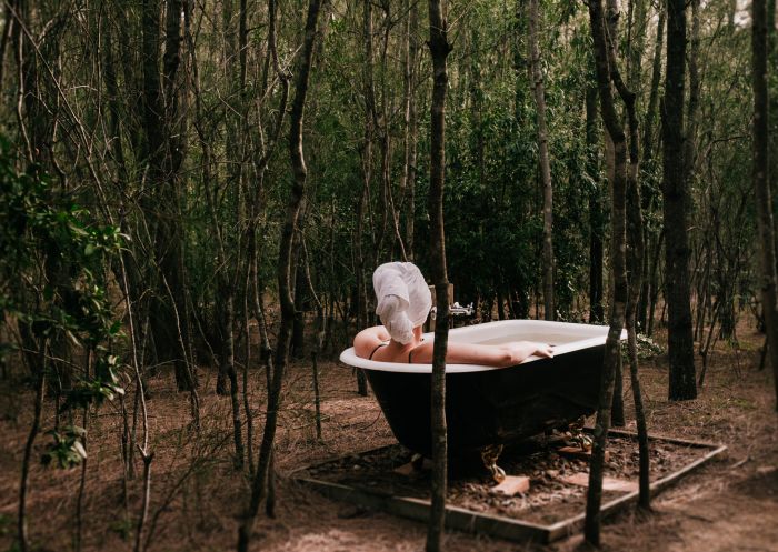 Woman enjoying outdoor bath at Billabong Moon – Tree Tops, Hunter Valley