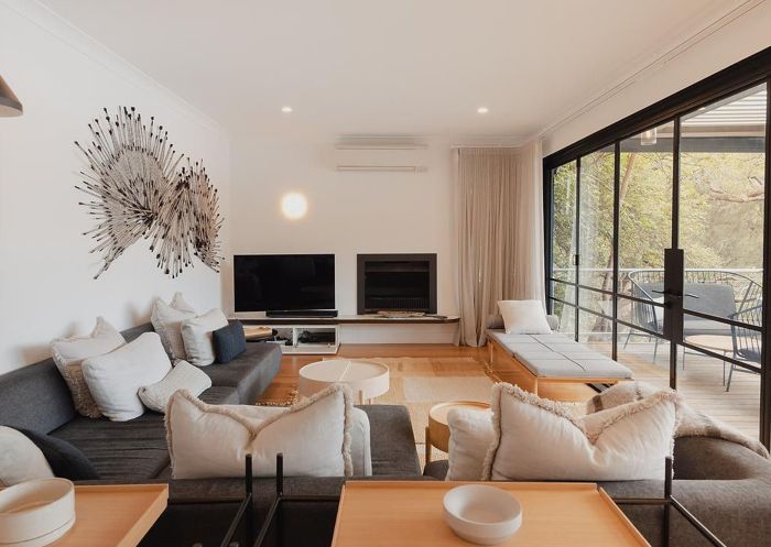 Living room with fireplace at Calabash Bay Lodge, Berowra Waters