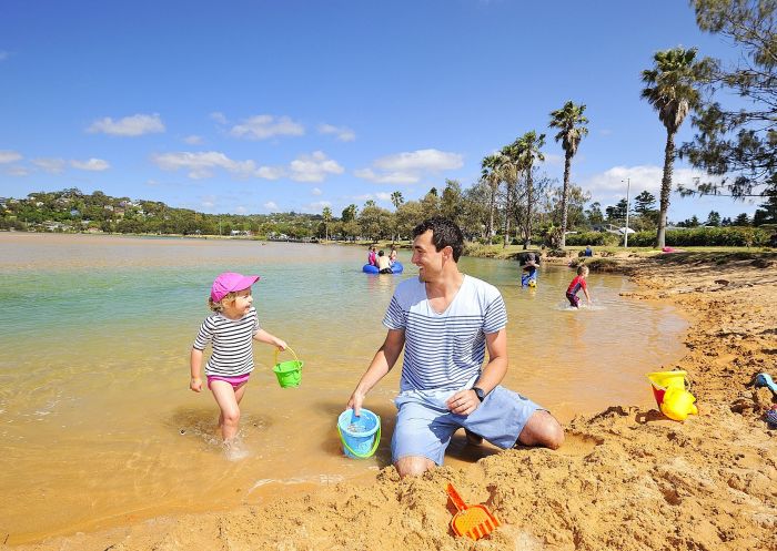 Father and daughter playing at the beach at BIG4 Sydney Lakeside Holiday Park, North Narrabeen