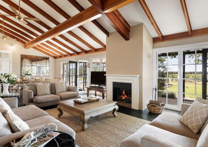 Living room with fireplace at Tinonee Vineyard Estate, Broke