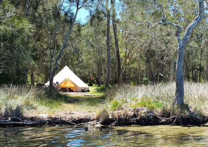 Scenic view of tent by the river at Simple Pleasures Camping Co, Forster
