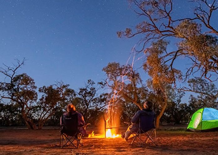 Campers stargazing by the fire at Emu Lake campground, Kinchega National Park