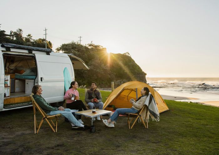 Friends enjoying ocean views from their campervan and tent at Coledale Beach, Wollongong 