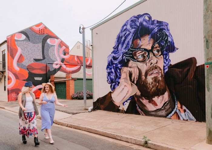 Women viewing the street art along Cadell Place at Lost Lane Murals, Wagga Wagga