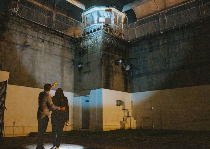 Couple enjoying a night tour at Maitland Gaol, Maitland