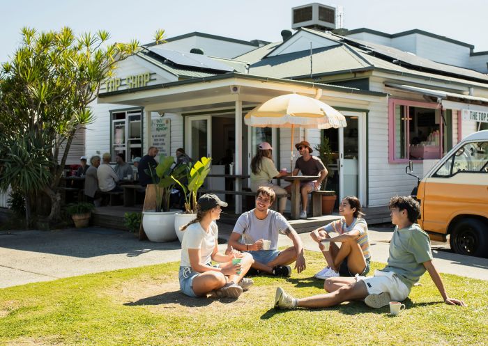 Friends enjoying a coffee on the lawn at Top Shop, Byron Bay