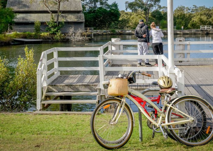 Couple with bikes overlooking the water, Jervis Bay