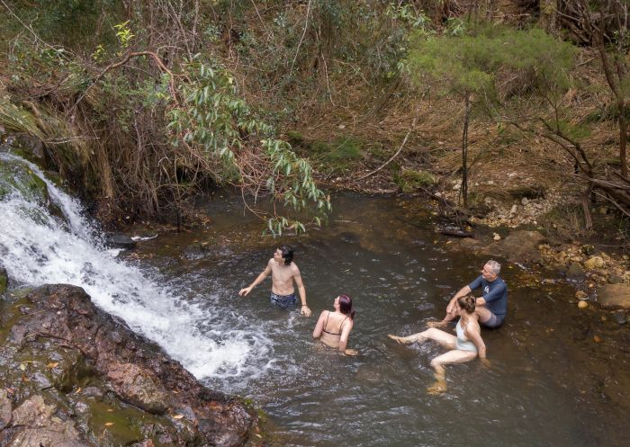 Friends enjoying waterfall with Byron Bay Adventure Tours at Nightcap National Park, Byron Bay