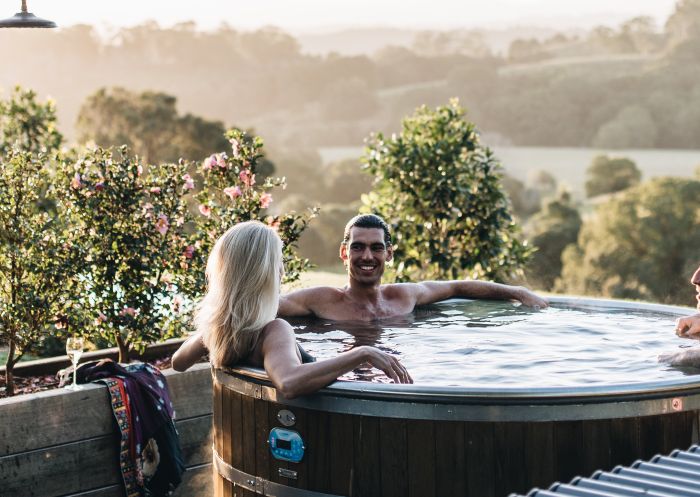 Friends enjoying an outdoor hot tub at The Brooklet, Brooklet