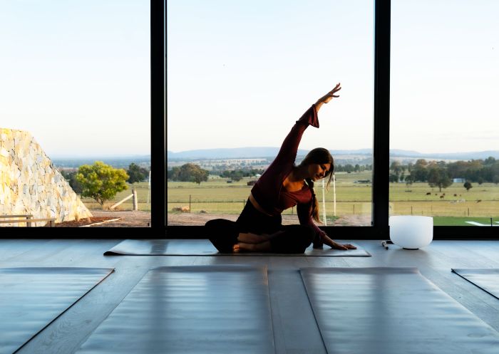 Woman practicing in yoga studio at Zensi Retreat, St Fillans 