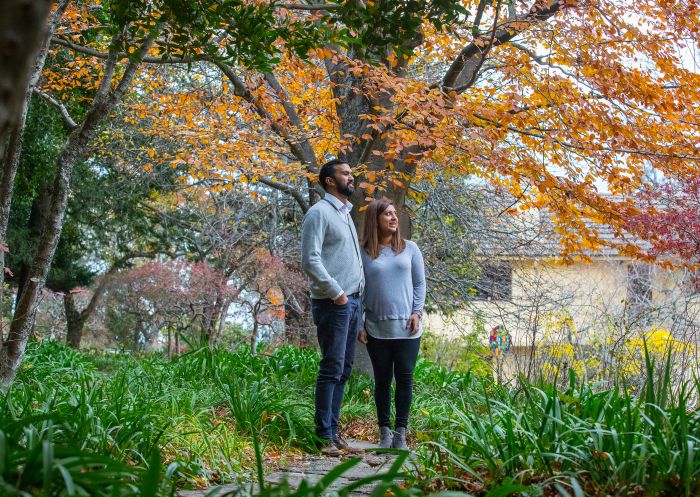 Couple enjoying a visit in autumn at Everglades Historic House and Gardens, Leura