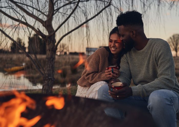 Couple enjoying campfire at Wilga Station, Evans Plains