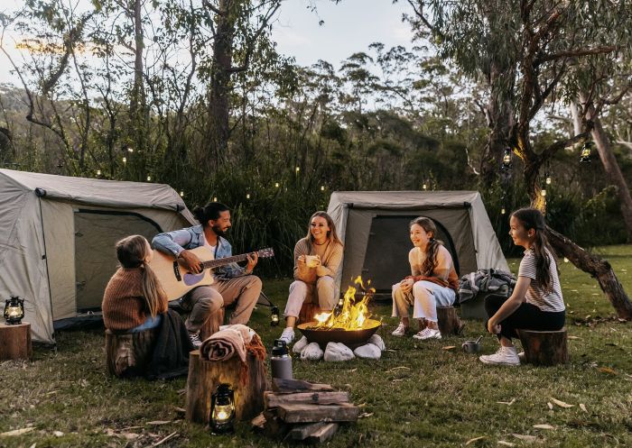 A family sitting around a campfire, BIG4 South Durras Holiday Park, South Durras