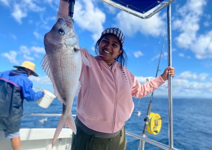 Woman catching a snapper, Cushy Fishing Charters, Tweed Heads - Credit: Kyle Cush