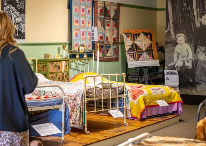 Visitor walking through the blanket collection, Pioneer Women's Hut Museum, Tumbarumba - Credit: Lightbox Imageworks