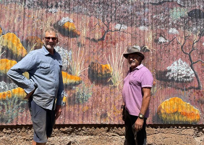 The two artists standing in front of landscape mural, The Shed, Broken Hill - Credit: The Shed