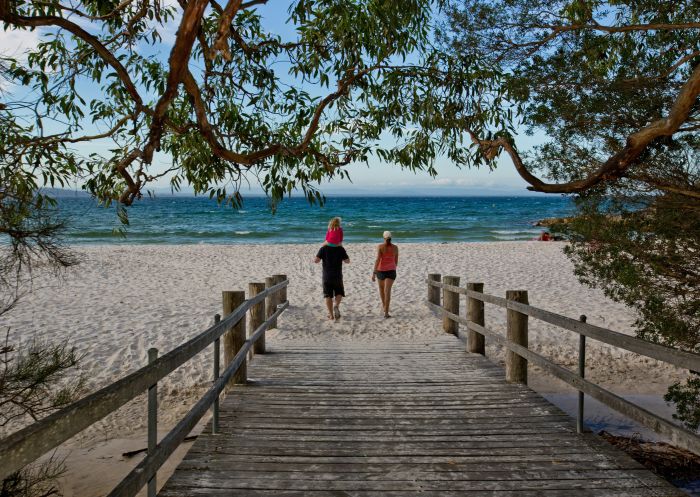 Family walking to beach from boardwalk, Booderee National Park: Green Patch Camping Area, Jervis Bay - Credit: Jon Harris | Parks Australia